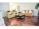 Open concept living room featuring a dark wood floor and neutral-toned couches with comfortable throw pillows at 3851 Bogan Mill Rd, Buford, GA 30519