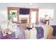 Bright and open living room features a fireplace, wood paneling, and a view into the adjacent dining area at 3851 Bogan Mill Rd, Buford, GA 30519