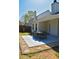 Covered patio features a dining table with six chairs, surrounded by landscaping and a fenced yard at 3851 Bogan Mill Rd, Buford, GA 30519
