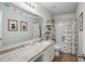 Bright bathroom with a spacious countertop, playful decor, and a shower-tub combination at 531 S Fortune Way, Dallas, GA 30157