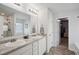 Bathroom with dual sink vanity, neutral walls and door to closet at 531 S Fortune Way, Dallas, GA 30157