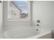 Relaxing bathtub area featuring a large soaking tub and window with natural light at 531 S Fortune Way, Dallas, GA 30157