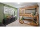 Charming bedroom featuring a unique bunk bed design and stylish green accent wall at 531 S Fortune Way, Dallas, GA 30157