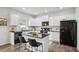 Modern kitchen featuring an island, white cabinets, stainless steel appliances and stone countertops at 531 S Fortune Way, Dallas, GA 30157
