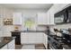 Modern kitchen featuring white cabinets, stainless steel appliances, stone countertops, and lots of light at 531 S Fortune Way, Dallas, GA 30157