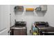 Convenient laundry room equipped with modern appliances and overhead shelving for storage solutions at 531 S Fortune Way, Dallas, GA 30157