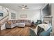 Inviting living room featuring a comfortable sectional sofa, fireplace, and ample natural light at 531 S Fortune Way, Dallas, GA 30157
