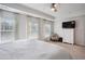 Large primary bedroom with tray ceiling, neutral walls, and three large windows at 531 S Fortune Way, Dallas, GA 30157