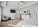 Large bedroom with tray ceilings, neutral walls, large TV and comfortable chair at 531 S Fortune Way, Dallas, GA 30157