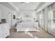 Bright main bedroom with a tray ceiling, plush bedding, and generous natural light at 531 S Fortune Way, Dallas, GA 30157