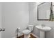 Bright half bathroom features a pedestal sink, wood floors and neutral paint at 6270 Shiloh Woods Dr, Cumming, GA 30040