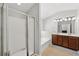 Bathroom with a glass door shower, soaking tub, and double vanity at 6270 Shiloh Woods Dr, Cumming, GA 30040