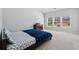 A cozy bedroom featuring plush carpeting and natural light from three windows at 6270 Shiloh Woods Dr, Cumming, GA 30040
