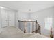 Hallway featuring a wooden railing and chandelier at 6270 Shiloh Woods Dr, Cumming, GA 30040
