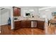 View of the kitchen with stainless steel appliances, granite counters and hardwood floors at 6270 Shiloh Woods Dr, Cumming, GA 30040