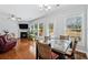 Living room with fireplace, hardwood floors, many windows and lots of natural light at 6270 Shiloh Woods Dr, Cumming, GA 30040