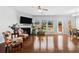 Spacious living room featuring a fireplace, hardwood floors, and access to a dining area at 6270 Shiloh Woods Dr, Cumming, GA 30040