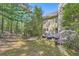Lush backyard featuring a brick patio, mature trees, and blooming flowers at 7155 Roswell Rd # 15, Atlanta, GA 30328