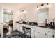 Elegant bathroom with dual sinks, dark countertops, and views into an adjoining bedroom at 7155 Roswell Rd # 15, Atlanta, GA 30328
