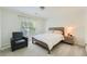 Inviting bedroom with a comfortable bed, side table, and a cozy armchair by the window at 7155 Roswell Rd # 15, Atlanta, GA 30328