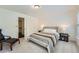 Bright bedroom with carpet, a comfortable bed, and a view to the staircase and front door at 7155 Roswell Rd # 15, Atlanta, GA 30328