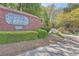 Entrance to the Wynngate community with brick signage and landscaping at 7155 Roswell Rd # 15, Atlanta, GA 30328