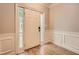 Inviting foyer showcasing hardwood floors, wainscoting, and a stylish front door with sidelights at 7155 Roswell Rd # 15, Atlanta, GA 30328