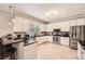Well-lit kitchen featuring granite countertops, stainless steel appliances, and breakfast bar seating at 7155 Roswell Rd # 15, Atlanta, GA 30328