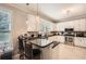 Charming kitchen featuring a breakfast bar with stools, granite countertops, and stainless appliances at 7155 Roswell Rd # 15, Atlanta, GA 30328