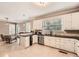 Bright kitchen features white cabinets, stainless appliances, and black granite countertops at 7155 Roswell Rd # 15, Atlanta, GA 30328