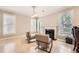 Comfortable living room featuring chairs, a fireplace, and natural light from the surrounding windows at 7155 Roswell Rd # 15, Atlanta, GA 30328