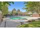Community pool surrounded by a concrete deck and lush landscaping at 7155 Roswell Rd # 15, Atlanta, GA 30328