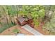 Aerial view of two story home with private driveway and mature trees in a wooded neighborhood at 1150 Autumn Ridge Dr, Marietta, GA 30066