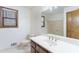 Well lit bathroom with a wooden framed window, framed mirror, and extended countertop at 1150 Autumn Ridge Dr, Marietta, GA 30066