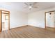 Bright bedroom with laminate flooring, ceiling fan, and two doorways to adjoining rooms at 1150 Autumn Ridge Dr, Marietta, GA 30066