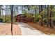Two story home with a private driveway surrounded by mature trees and natural landscaping at 1150 Autumn Ridge Dr, Marietta, GA 30066