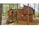 Wood exterior home with bay window, back deck, stairs, and screened porch surrounded by trees at 1150 Autumn Ridge Dr, Marietta, GA 30066