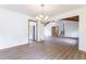 Bright living room features hardwood floors, chandelier, and open floor plan to kitchen and stairs at 1150 Autumn Ridge Dr, Marietta, GA 30066