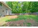 Large backyard featuring a spacious lawn, a wooden fence, and a patio area, perfect for outdoor living at 1171 Bailing Dr, Lawrenceville, GA 30043
