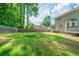 Expansive backyard with lush green grass, bordered by a wooden fence and mature trees, perfect for outdoor activities at 1171 Bailing Dr, Lawrenceville, GA 30043