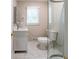Bright bathroom featuring a modern vanity with marble floors and a glass-enclosed shower at 1171 Bailing Dr, Lawrenceville, GA 30043