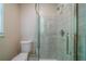 A clean bathroom with a glass shower door and modern tile walls at 1171 Bailing Dr, Lawrenceville, GA 30043