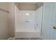 Full bathtub and shower combination with white tile at 1171 Bailing Dr, Lawrenceville, GA 30043