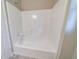 Full white tub and shower with white surround at 1171 Bailing Dr, Lawrenceville, GA 30043