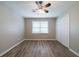 Bedroom featuring a ceiling fan, a window with blinds, a closet, and flooring at 1171 Bailing Dr, Lawrenceville, GA 30043