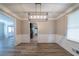 Dining area with modern lighting, updated floors, and open access to kitchen at 1171 Bailing Dr, Lawrenceville, GA 30043