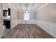 Bright dining room featuring hardwood floors, wainscoting, and modern light fixture at 1171 Bailing Dr, Lawrenceville, GA 30043