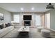 Bright living room featuring a fireplace with stone accents and neutral color palette at 1171 Bailing Dr, Lawrenceville, GA 30043