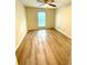 This bedroom has wood flooring, a window, ceiling fan and light fixtures at 2805 Ne Ne Expressway Ne # B-26, Atlanta, GA 30345