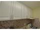 This kitchen features modern white cabinets and a tile backsplash at 2805 Ne Ne Expressway Ne # B-26, Atlanta, GA 30345